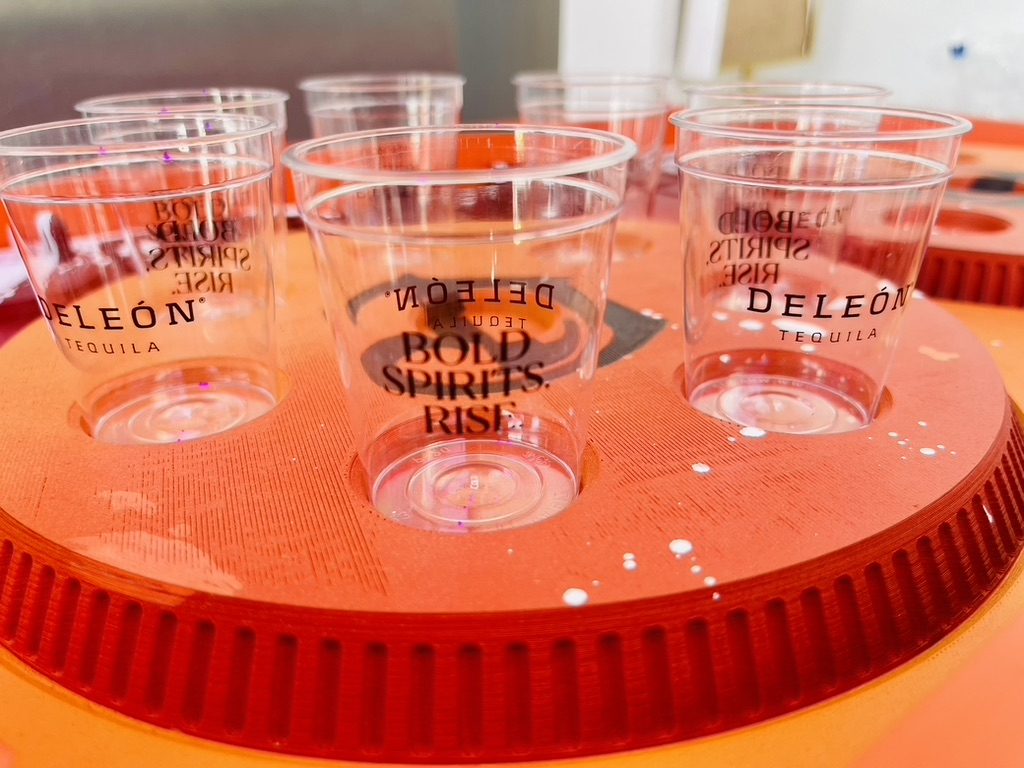 Branded DeLeón Tequila cups set in a turntable serving tray
