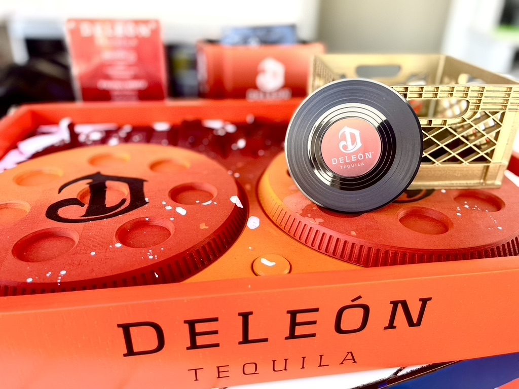 Custom DeLeón Tequila serving tray shaped like DJ turntables with a branded vinyl record